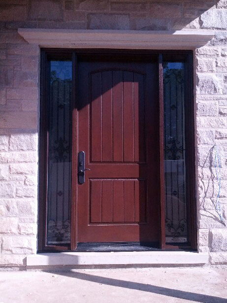 Fiberglass Woodgrain Rustic Front Door with 2 Frosted Side Lites and Iron Art Design installed by windowsanddoorstoronto.ca