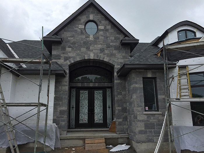 Wrought Iron Fiberglass Double Doors with 2 Iron Art Side Lites installed in new Home in Oakville