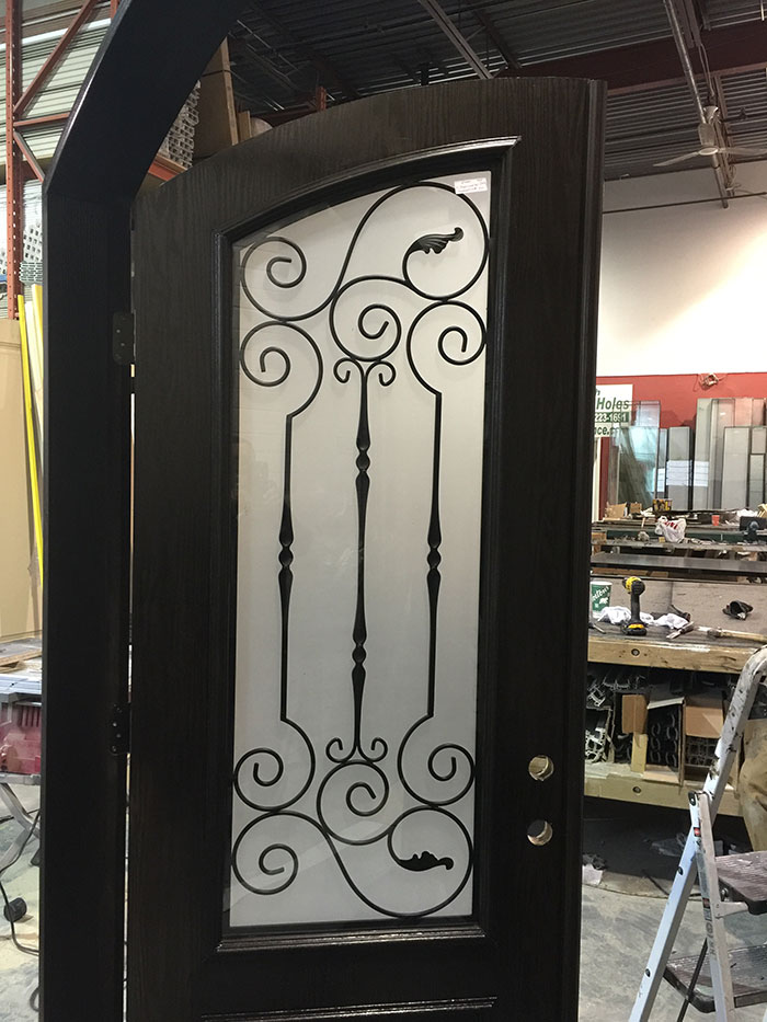 Arched Fiberglass Front Door with Iron Art Design and Frosted Glass During Manufacturing