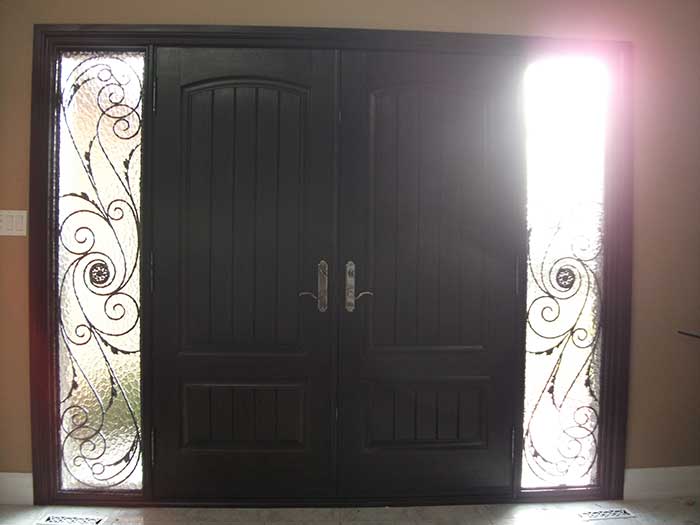 Wood grain Doors with Rustic and 2 Iron Art Side Lites Installed by Windows and Doors Toronto in Thornhill Ontario Inside View