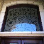 Wood grain Wrought Iron Doors with Iron Art Transom Installed by Windows and Doors Toronto