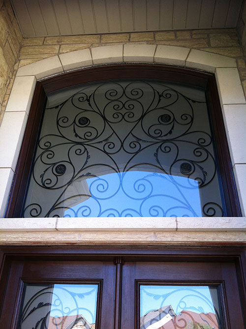 Wood grain Wrought Iron Doors with Iron Art Transom Installed by Windows and Doors Toronto