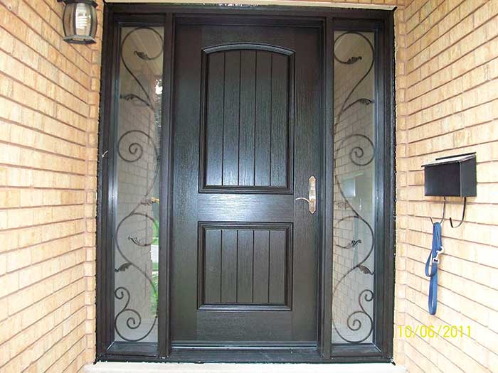 Rustic Door, Woodgrain Fiberglass front Single Door with 2 Iron Art Design installed by Windows and Doors Toronto