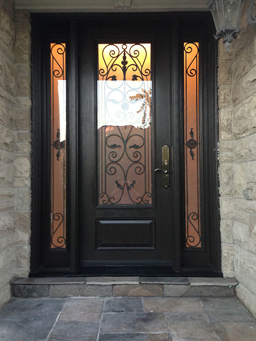 Woodgrain Wrought Iron Front Door with 2 Side lites installed in Richmond Hill by windowsanddoorstoronto