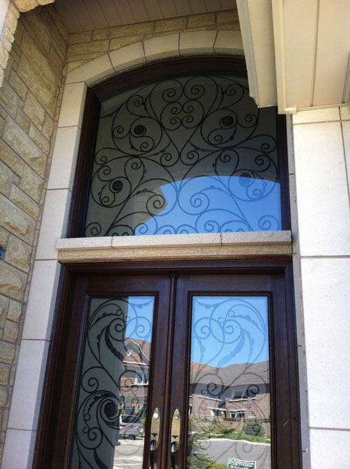 Wrought Iron Woodgrain Fiberglass Double Doors with Iron Art Transom Installed in Richmond Hill by Windows and Doors Toronto